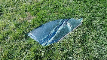 window thrown left in the grass