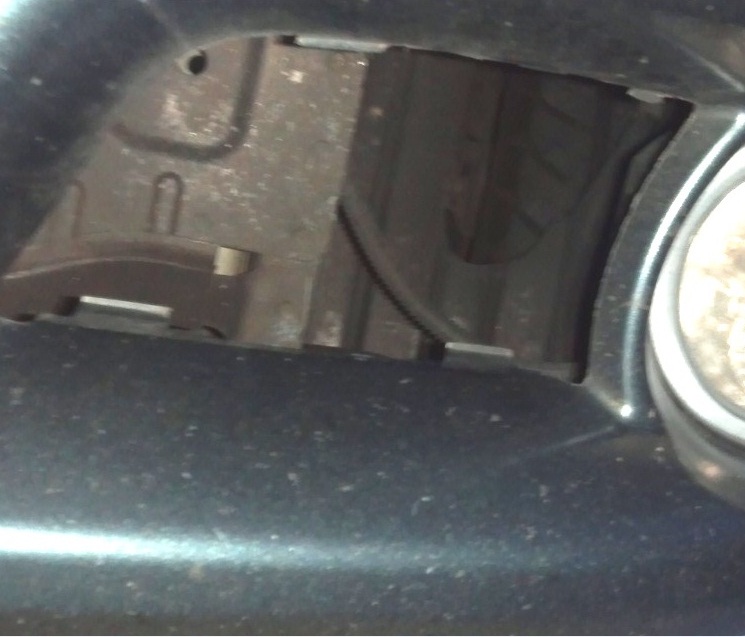Here you can see where the driver side grill came off.  It was a black grill. You can also see the rubbed out hole &amp; tire.