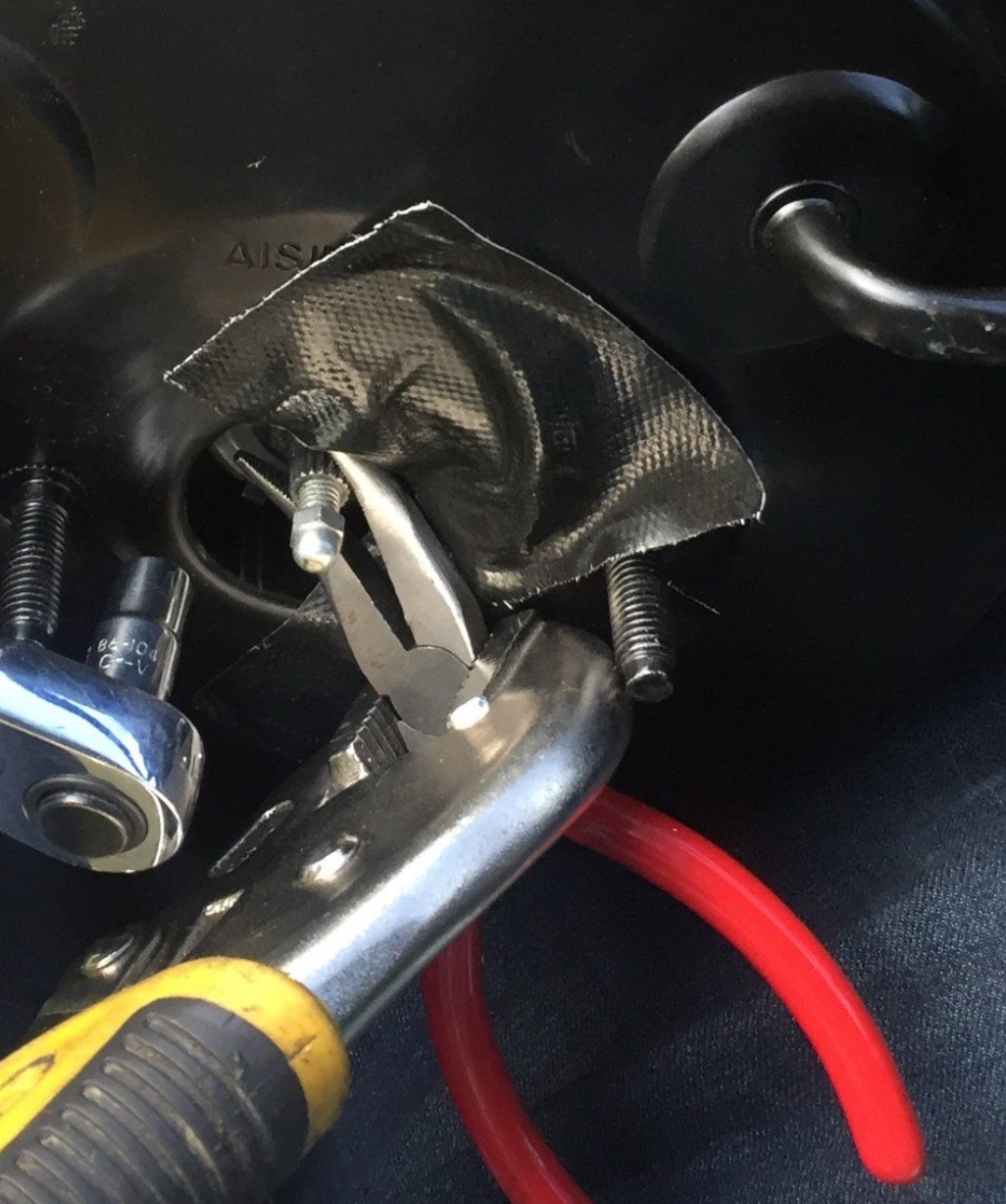 One way of trying to hold the brake booster rod!